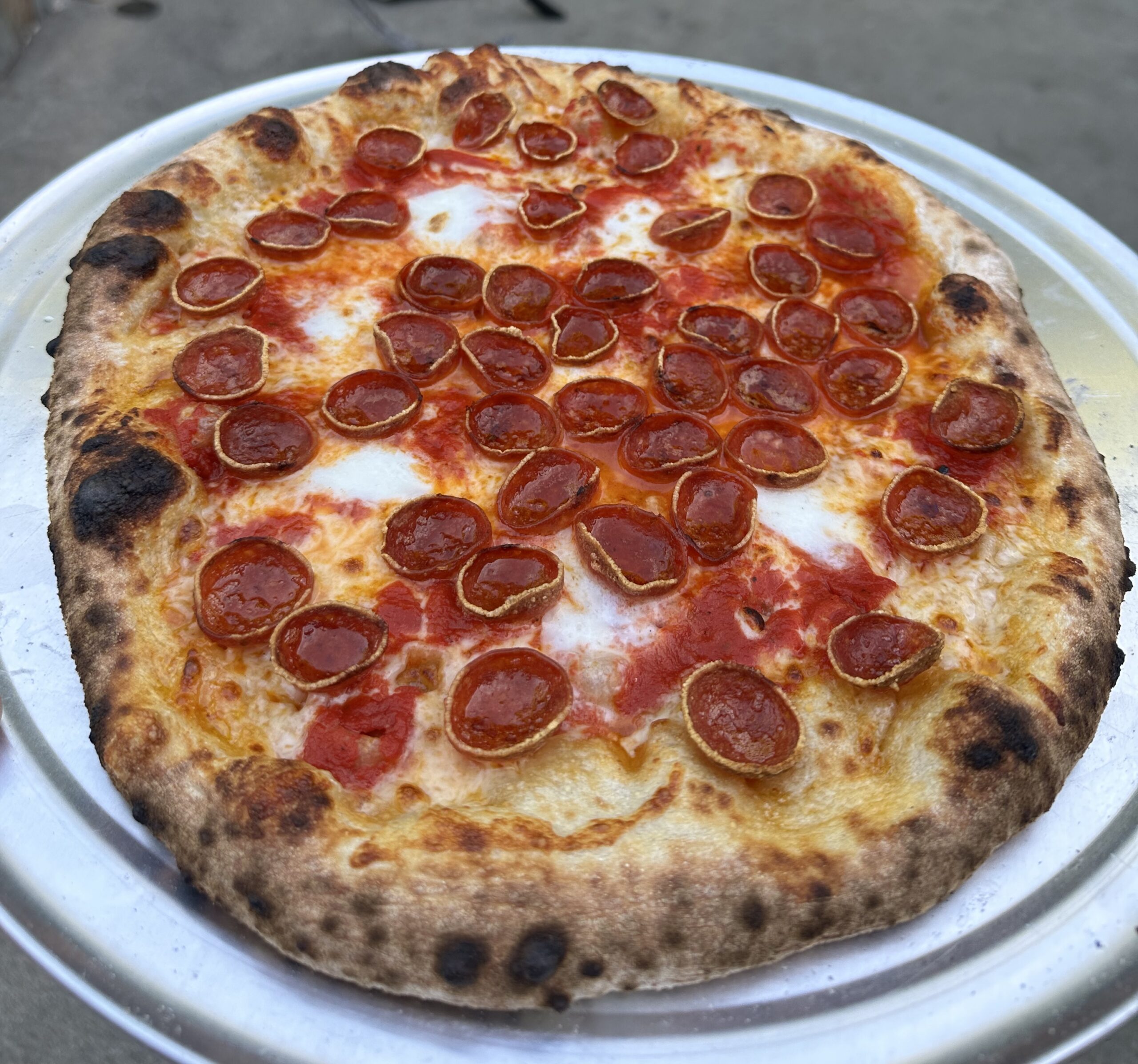 Blistered pepperoni pizza fresh from the oven